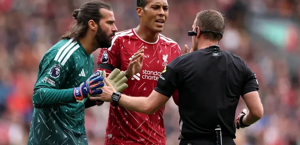 Liverpool players arguing with the referee during match