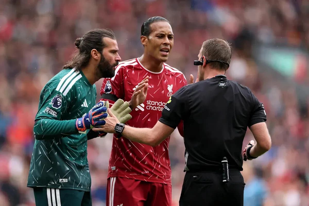 Liverpool players arguing with the referee during match