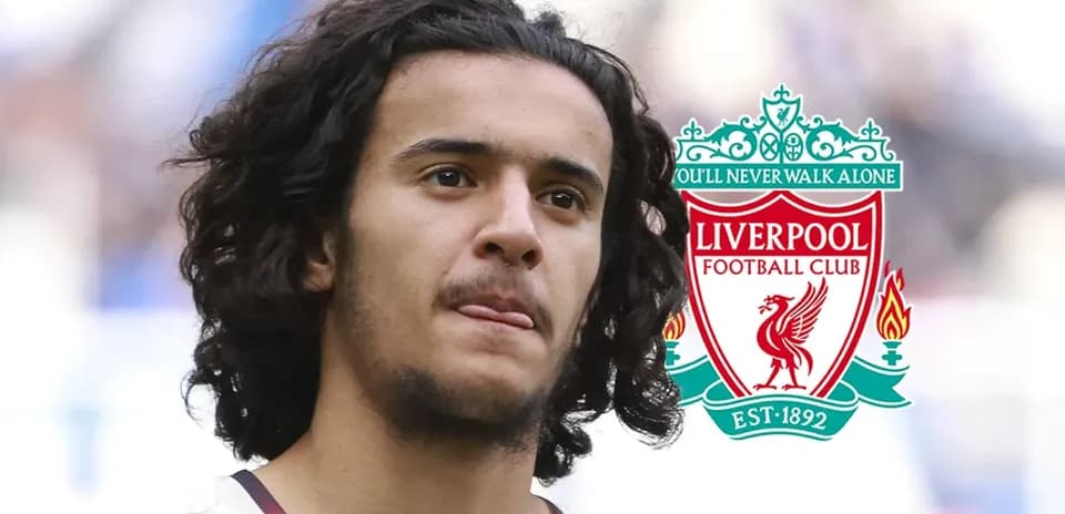 Player with long hair and Liverpool FC logo