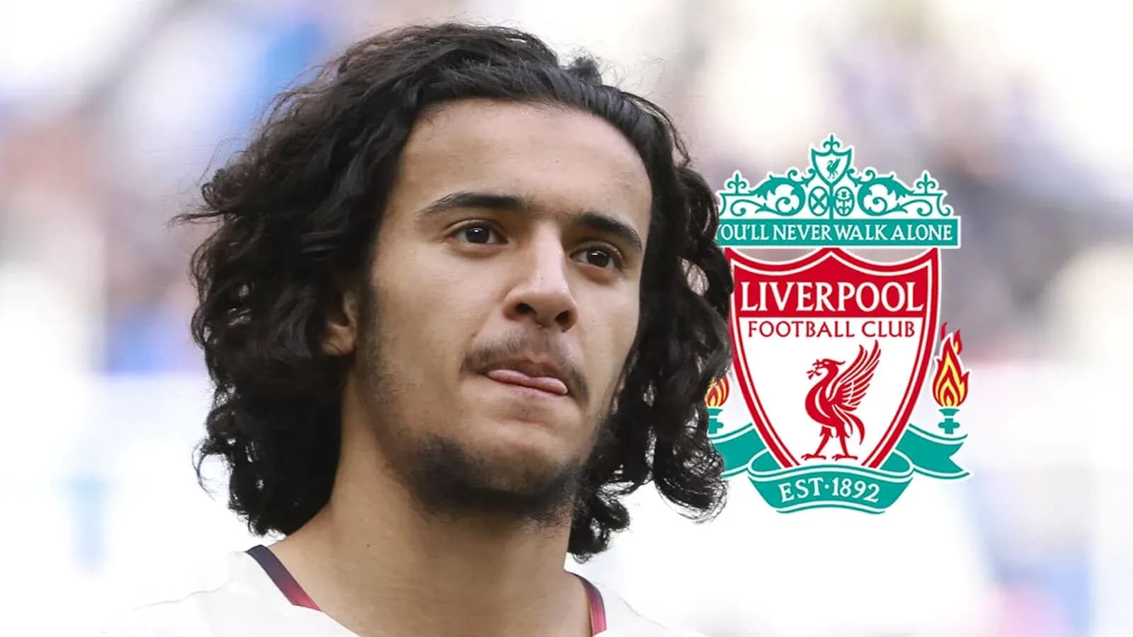Player with long hair and Liverpool FC logo