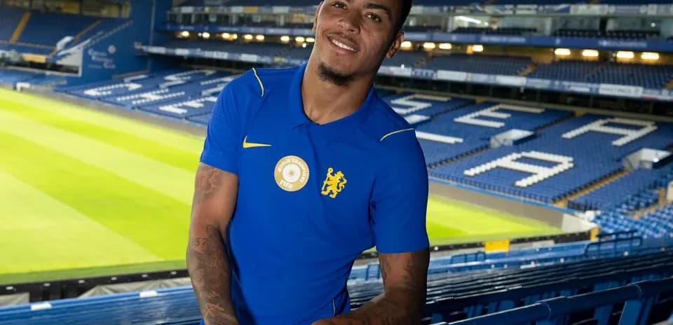 Player posing at stadium with green pitch background