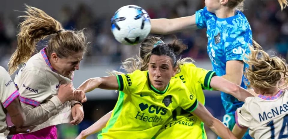 Players competing for the ball during NWSL match