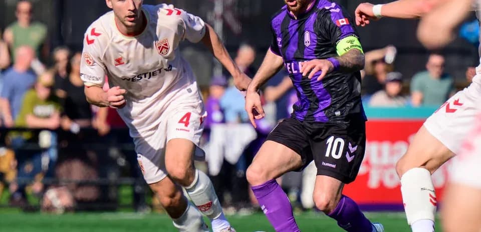Cavalry FC player dribbling the ball during match