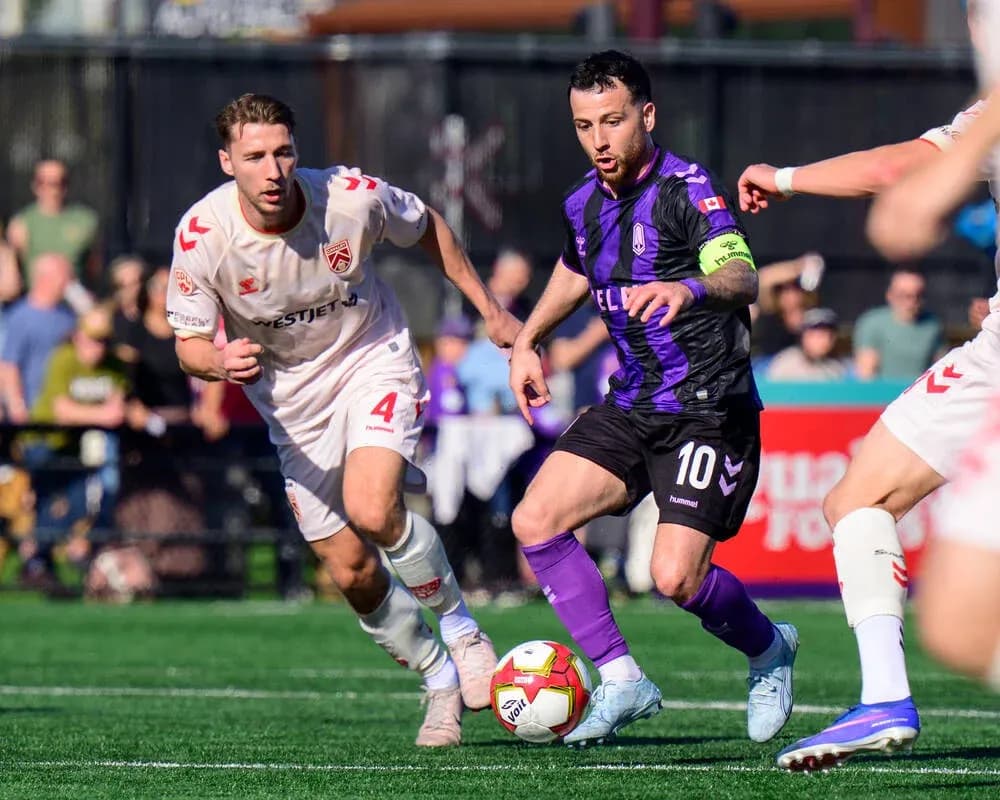 Cavalry FC player dribbling the ball during match