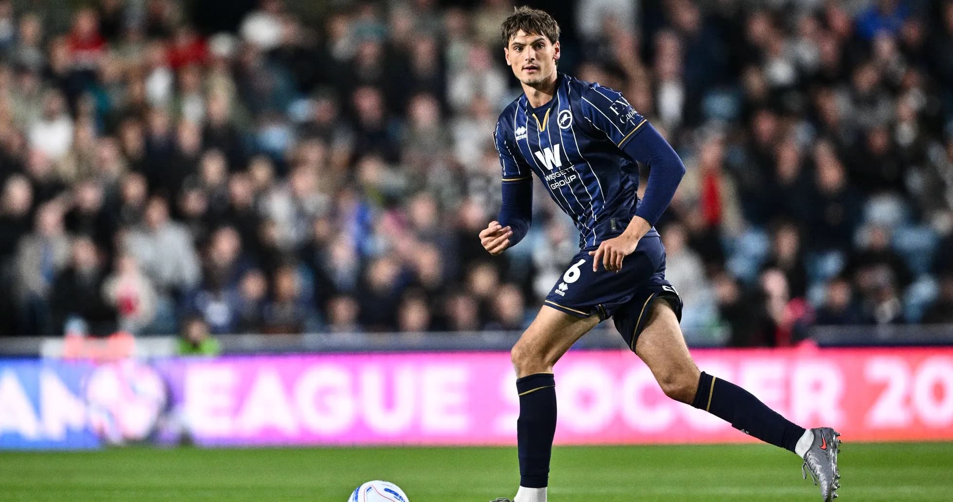 Player in blue kit running during a match