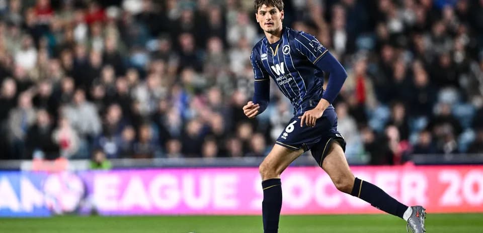 Player in blue kit running during a match