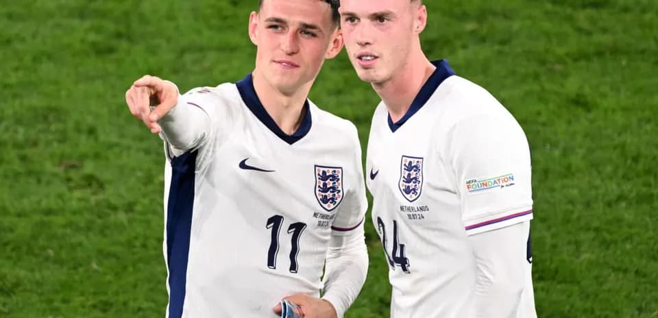 Two England players discussing on the field
