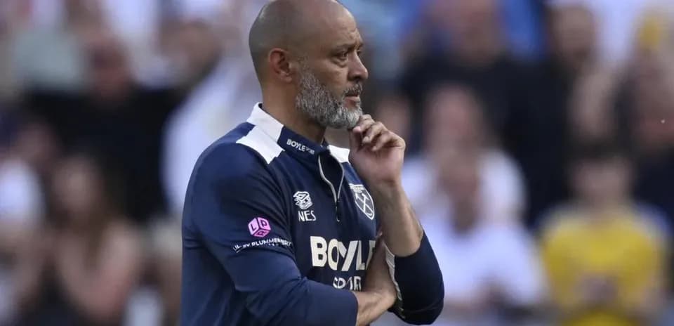 Manager observing match with hand on chin