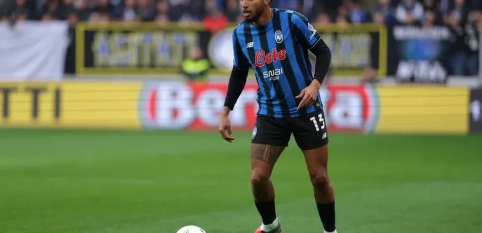 Player in Atalanta kit controlling ball during match