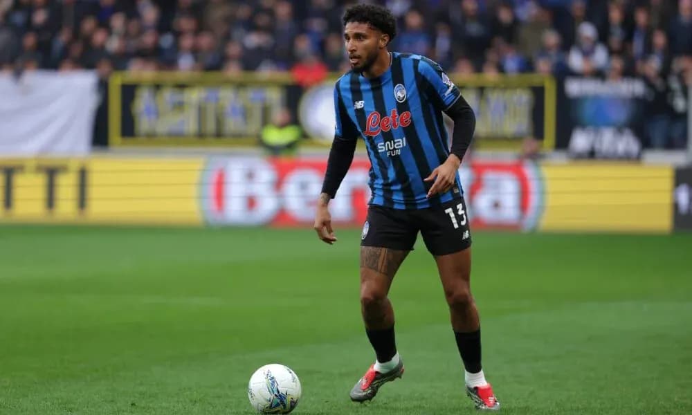 Player in Atalanta kit controlling ball during match