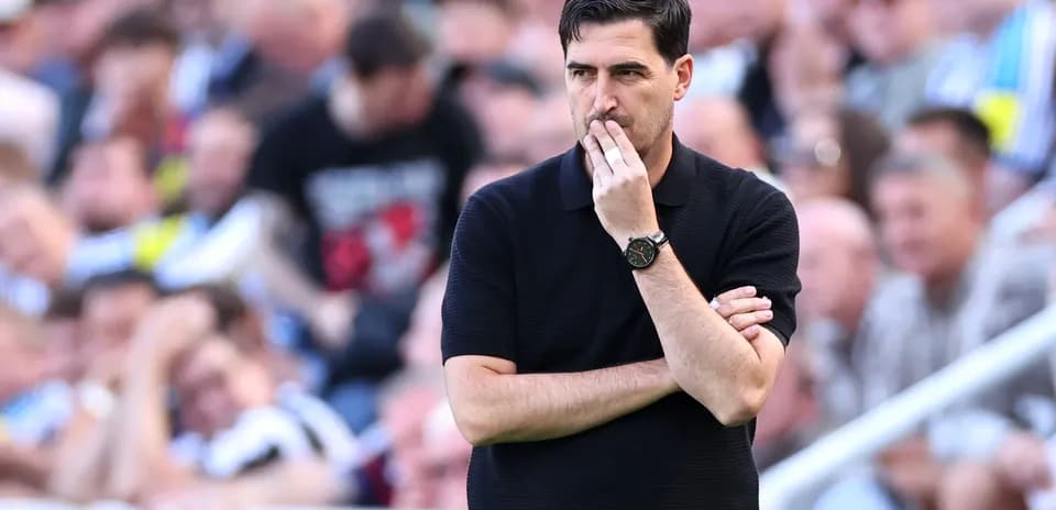 Coach observing the match with arms crossed