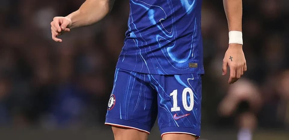 Player in Chelsea kit with ball on pitch