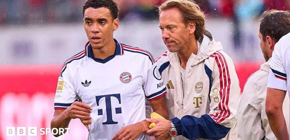 Player receiving medical attention from staff on field