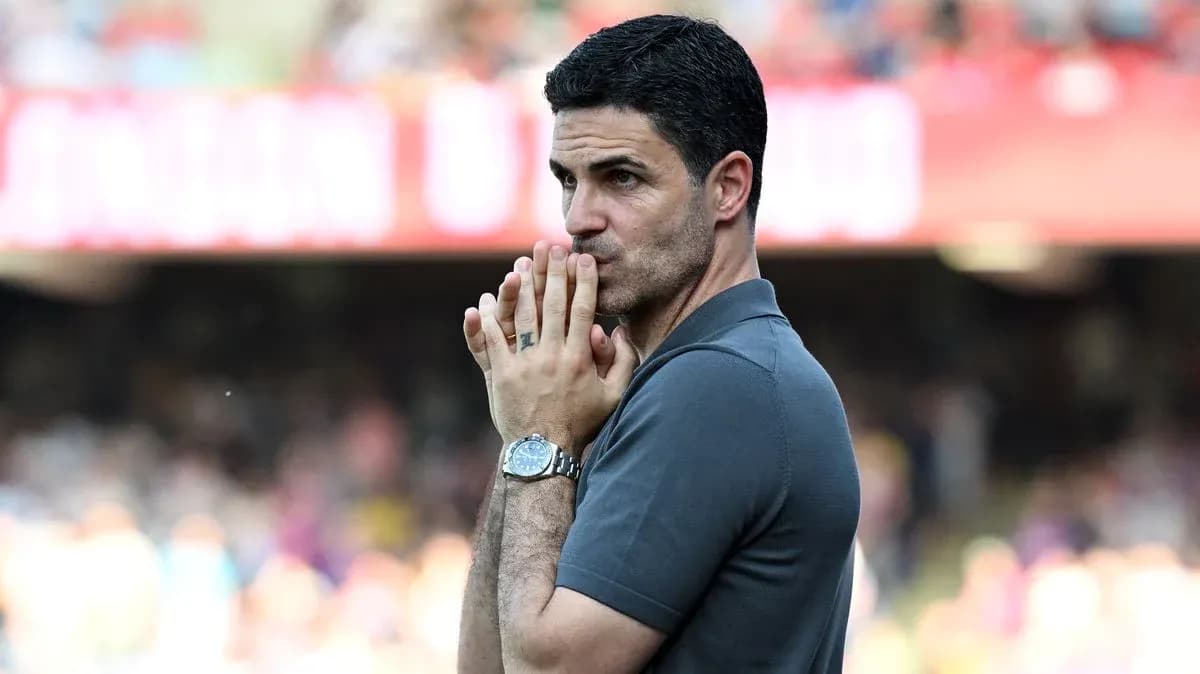 Coach observing match with hands clasped in front