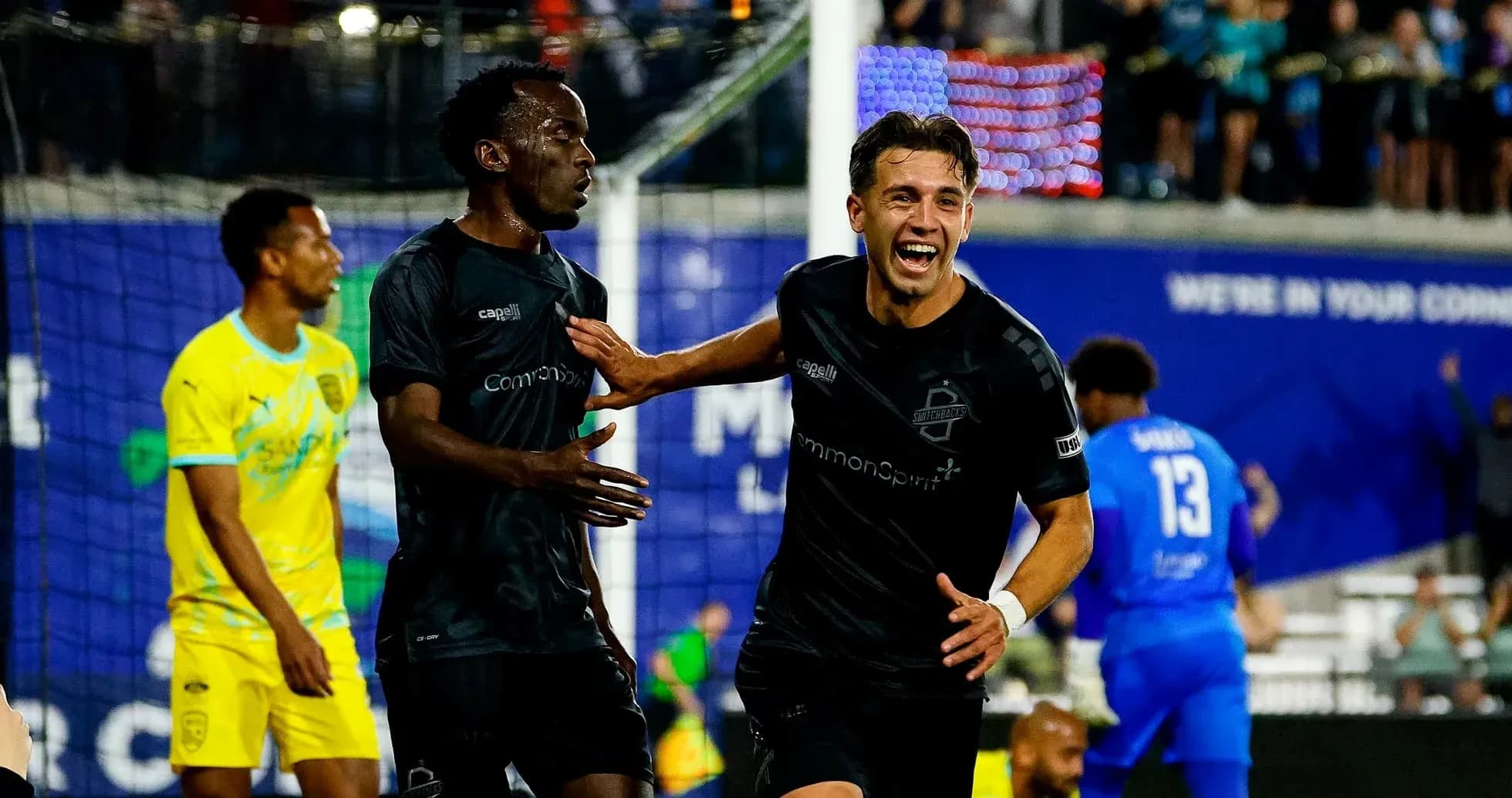 Players celebrating goal during FC Tulsa match