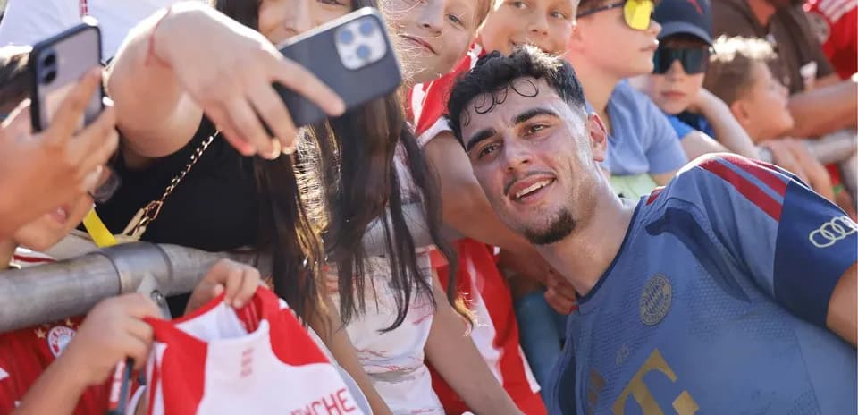 Player taking selfie with young fans at event