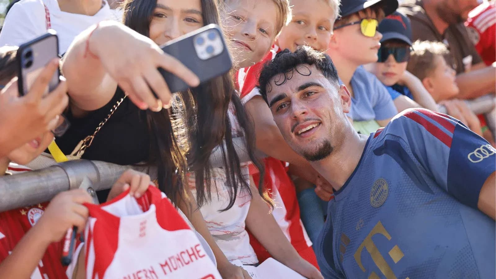 Player taking selfie with young fans at event