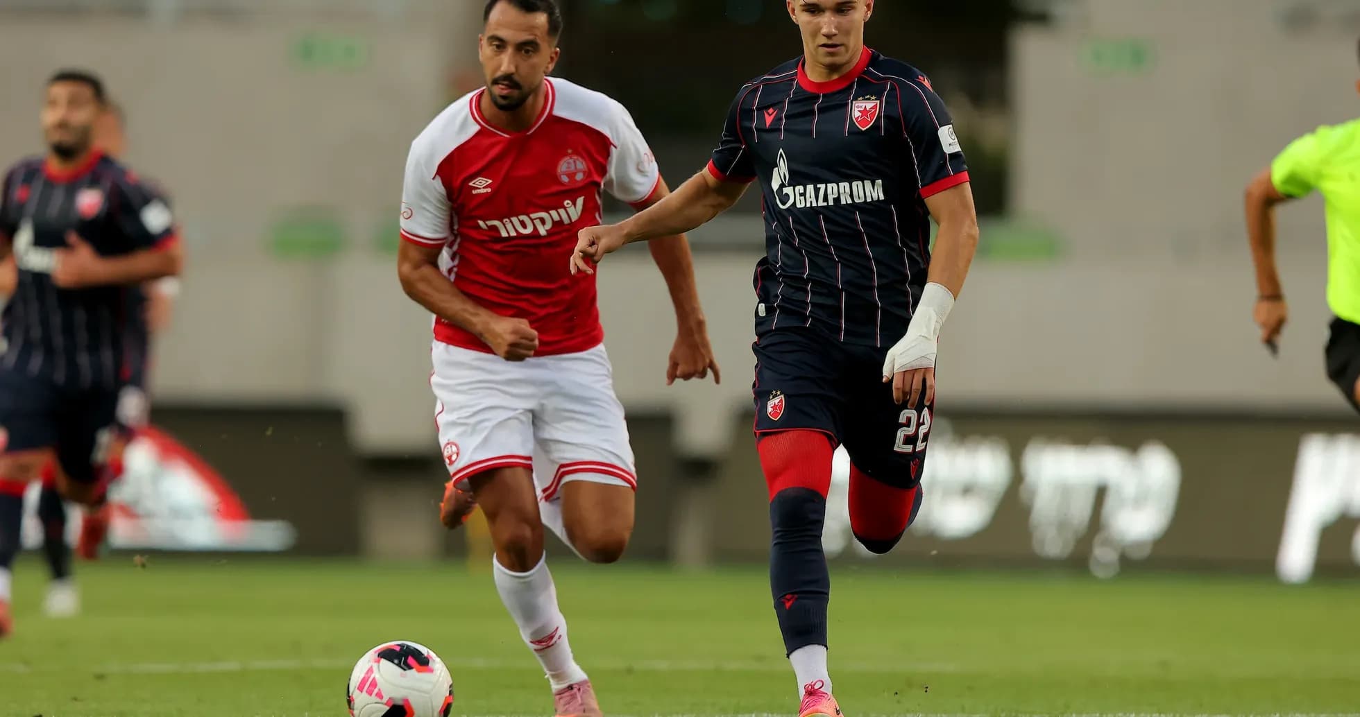 Crvena Zvezda player dribbling past Hapoel Beer Sheva player