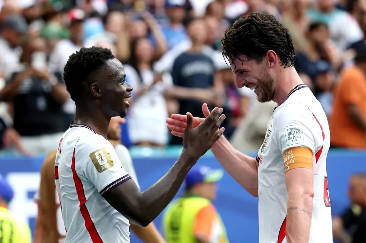 Two players celebrating with a handshake on the field
