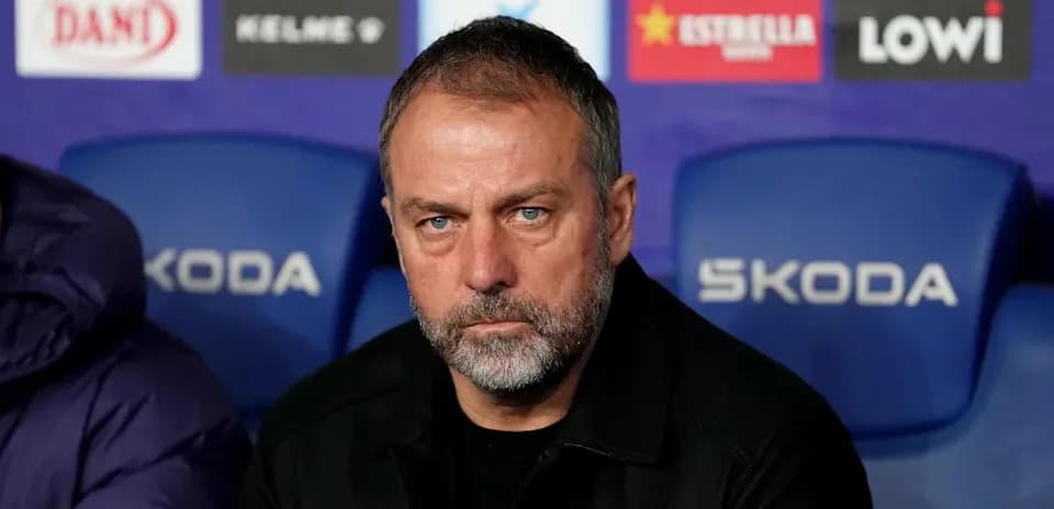Coach seated on bench during match preparation
