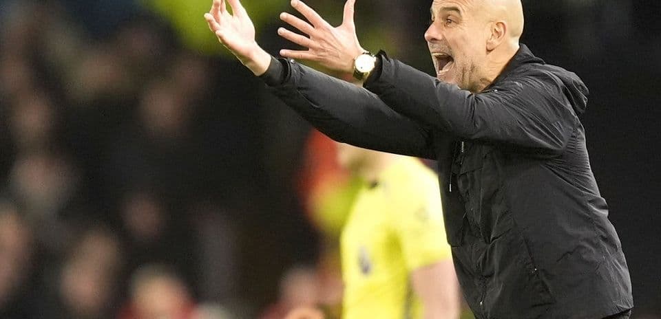 Manager gesturing passionately during match on sidelines