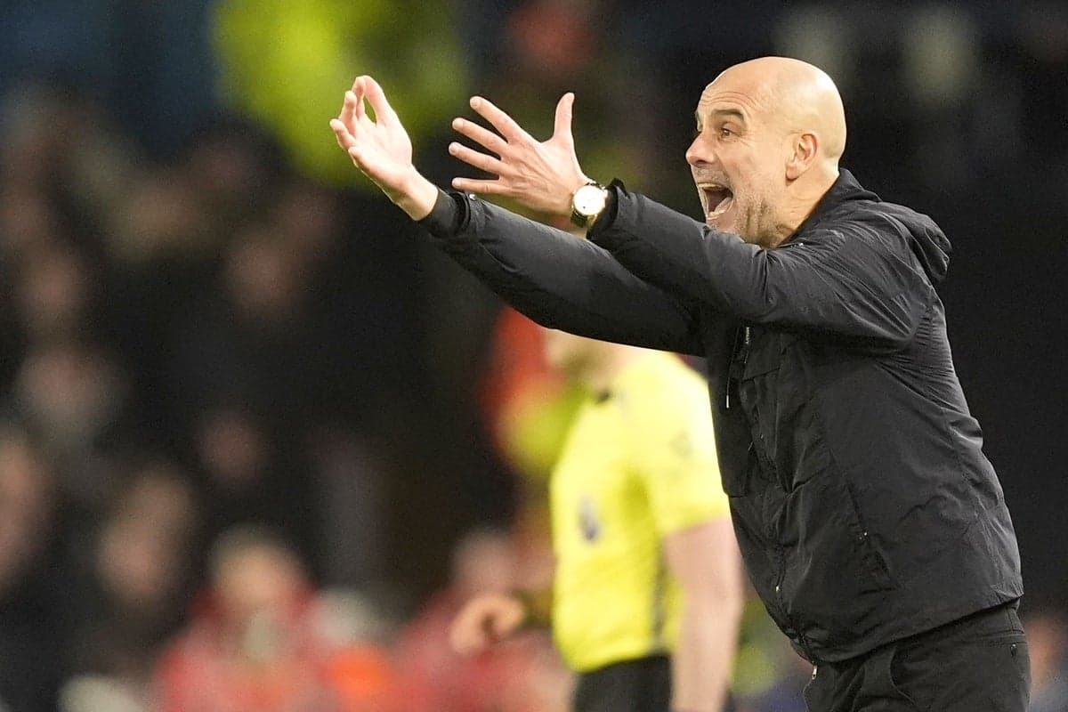 Manager gesturing passionately during match on sidelines