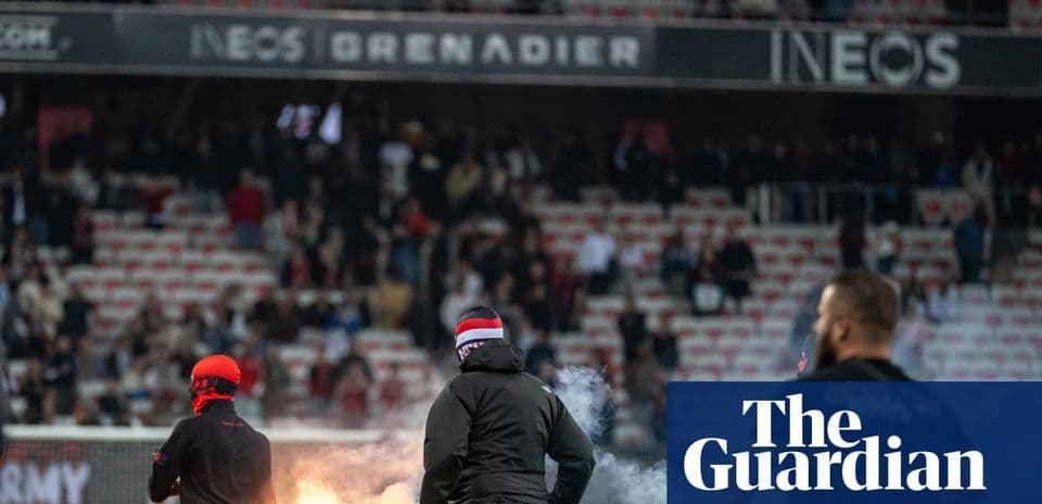 Fans lighting flares during a football match
