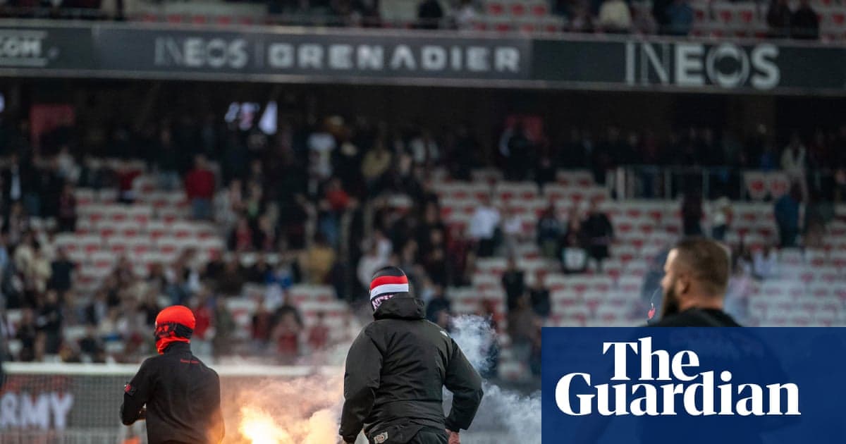 Fans lighting flares during a football match