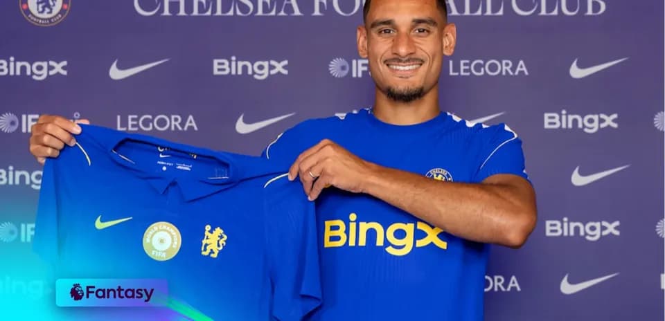 Player holding Chelsea jersey during signing event
