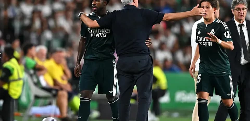 Coach instructing players during a match substitution