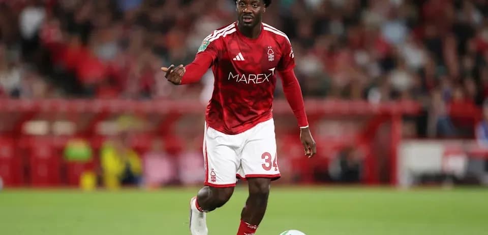Player in red kit directing play on the field