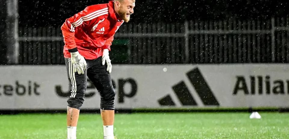 Goalkeeper training in the rain on the pitch