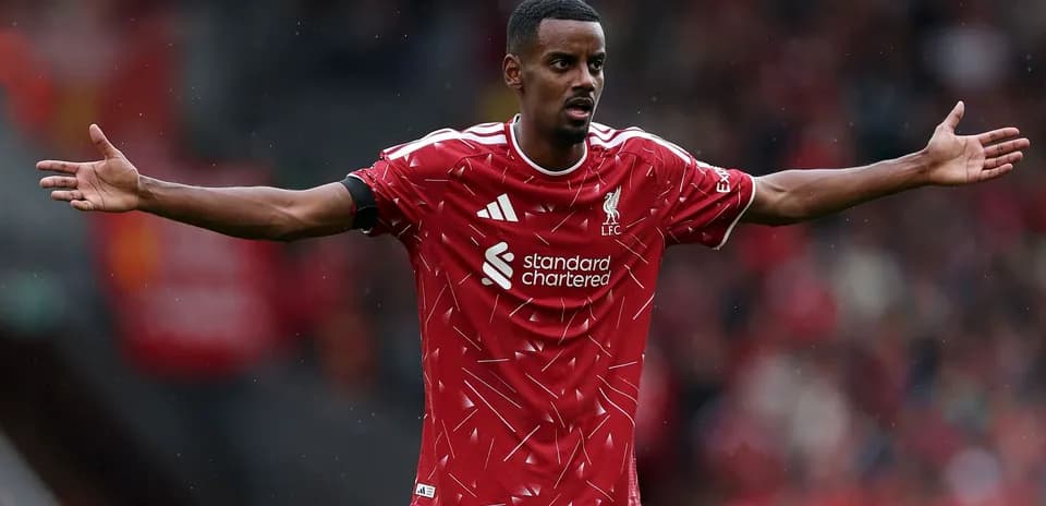 Player gesturing during match in Liverpool kit