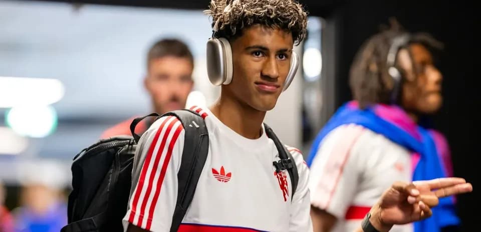 Player wearing headphones walking in locker room