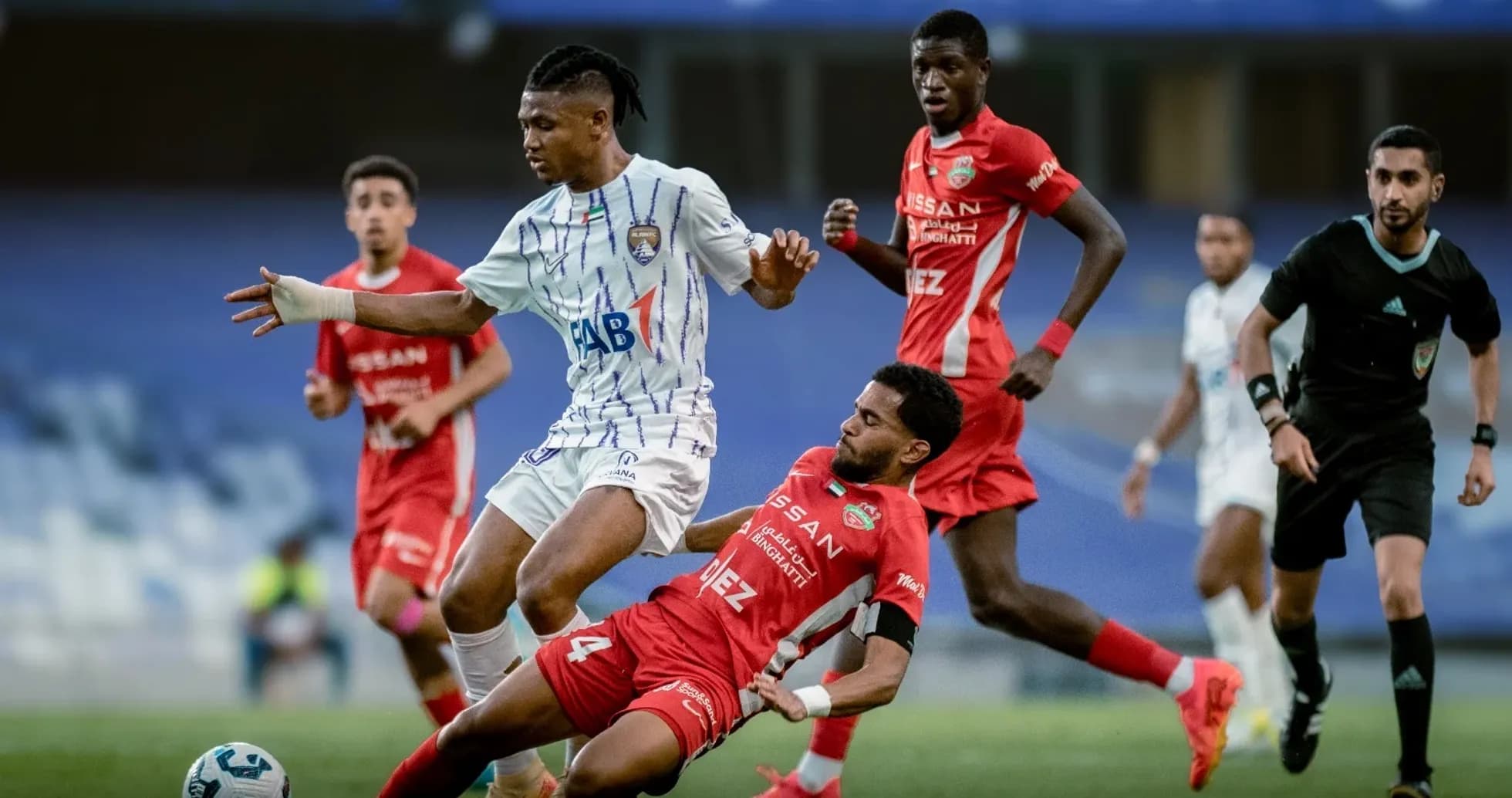 Al Ain U23 player challenging Al Sharjah U23 opponent