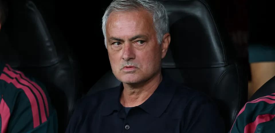 Coach seated on bench during a match