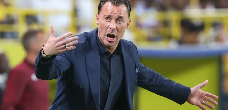 Coach gesturing passionately during a match