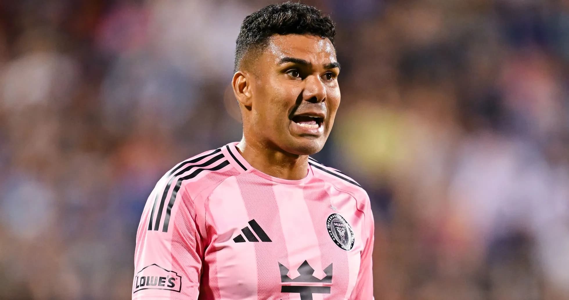 Player in pink jersey shouting during soccer match