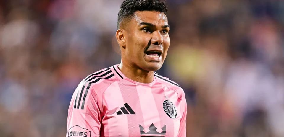 Player in pink jersey shouting during soccer match