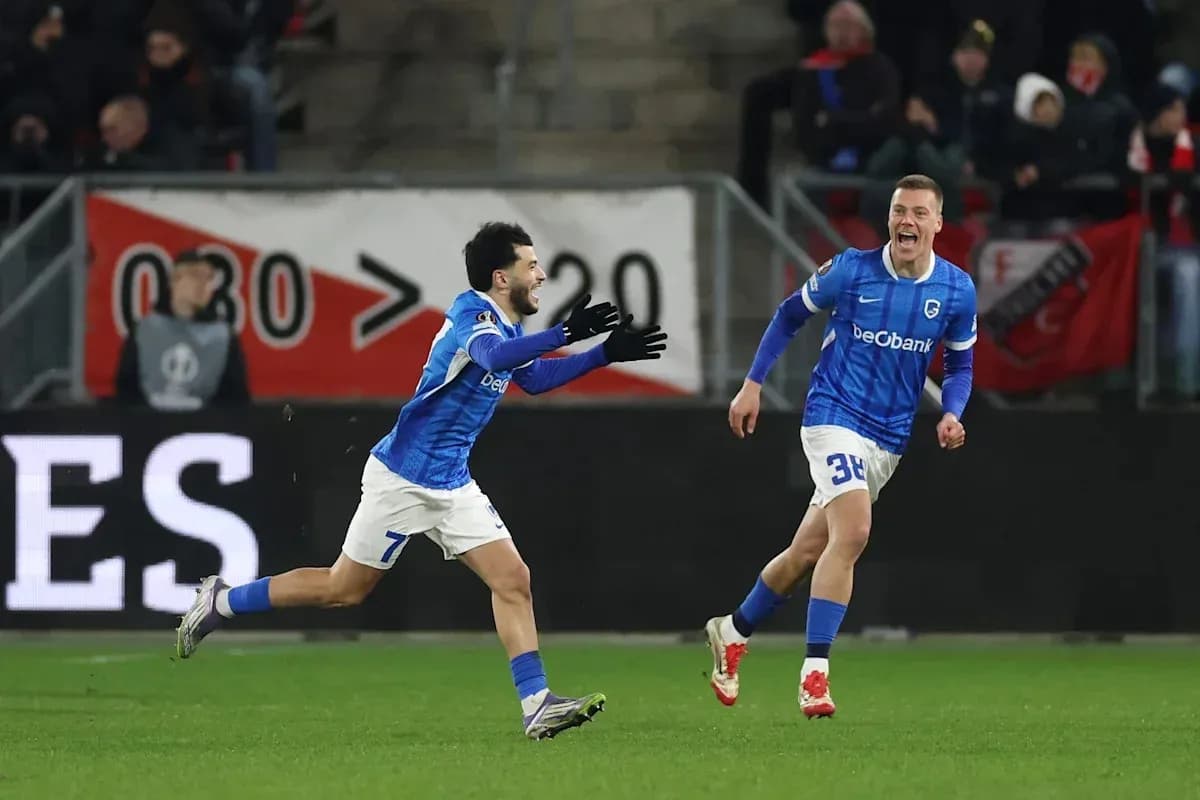Two players celebrating a goal on the field