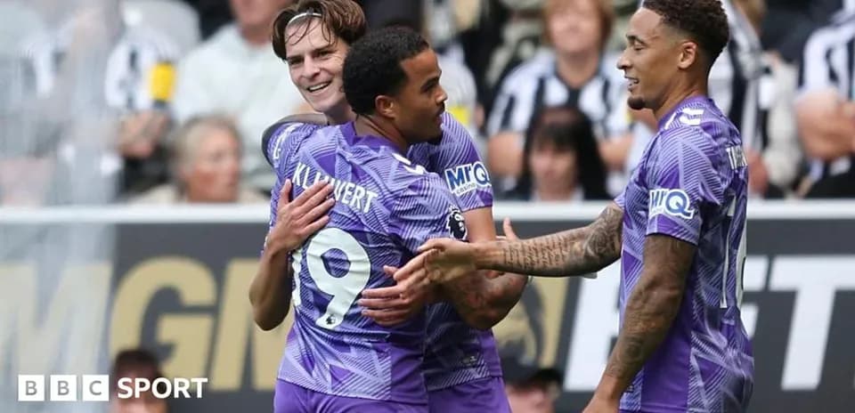 Players celebrating a goal on the pitch