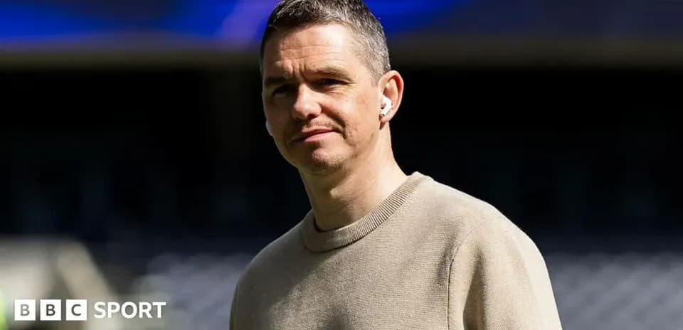 Man wearing earbuds at a sports venue