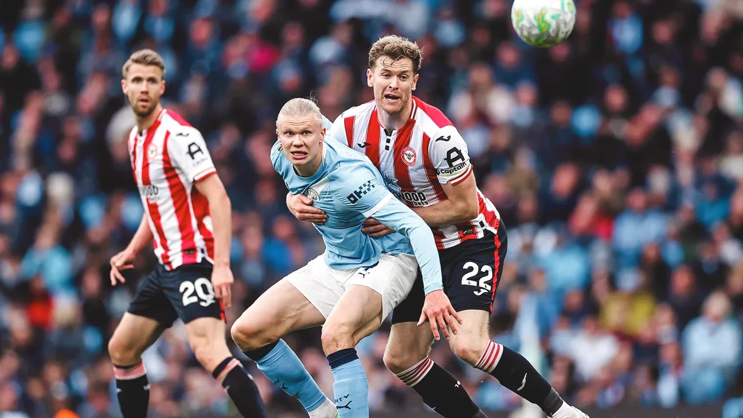 Erling Haaland challenged by Brentford defender