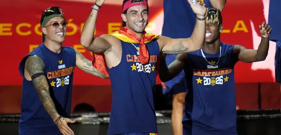 Players celebrating with medals and flags on stage