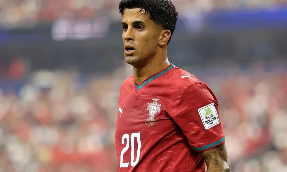 Player wearing red Portugal jersey on field Player wearing red Portugal jersey on field
