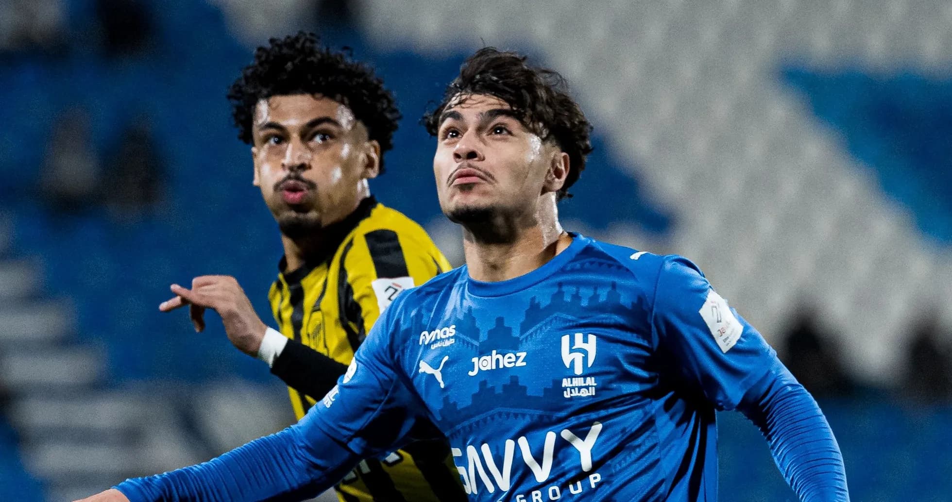 Two players competing during a football match Two players competing during a football match