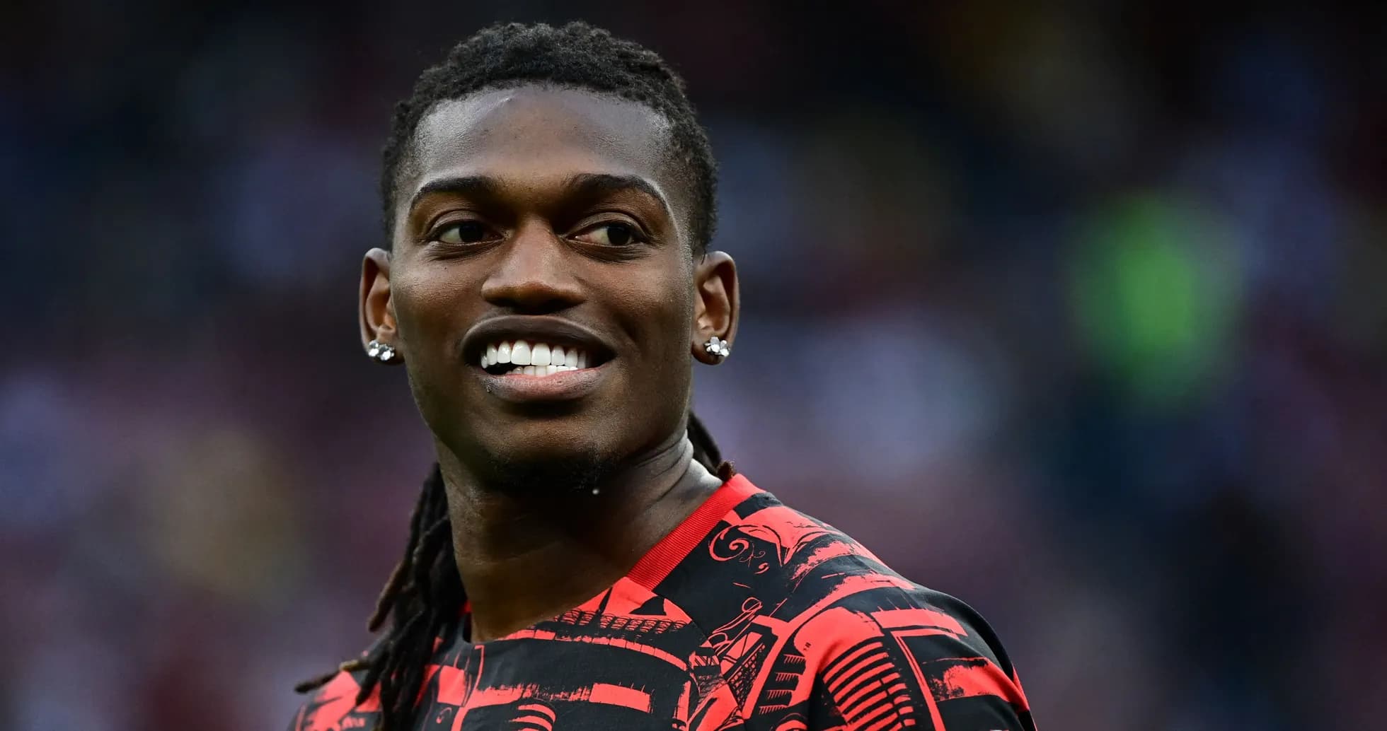 Player smiling in red and black patterned jersey Player smiling in red and black patterned jersey