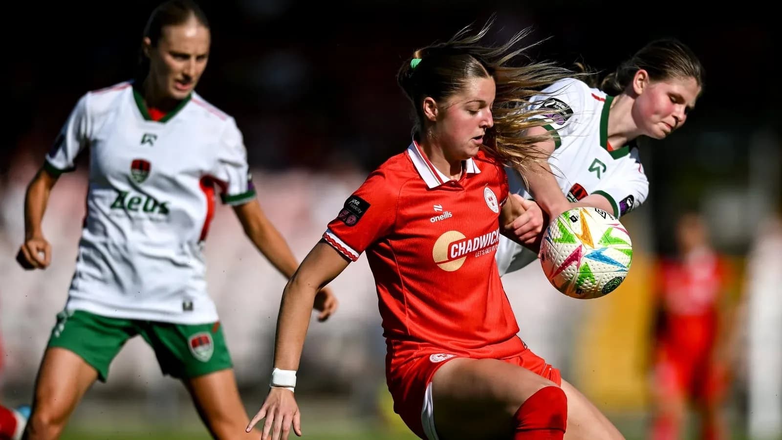 Two players competing for the ball in a match Two players competing for the ball in a match
