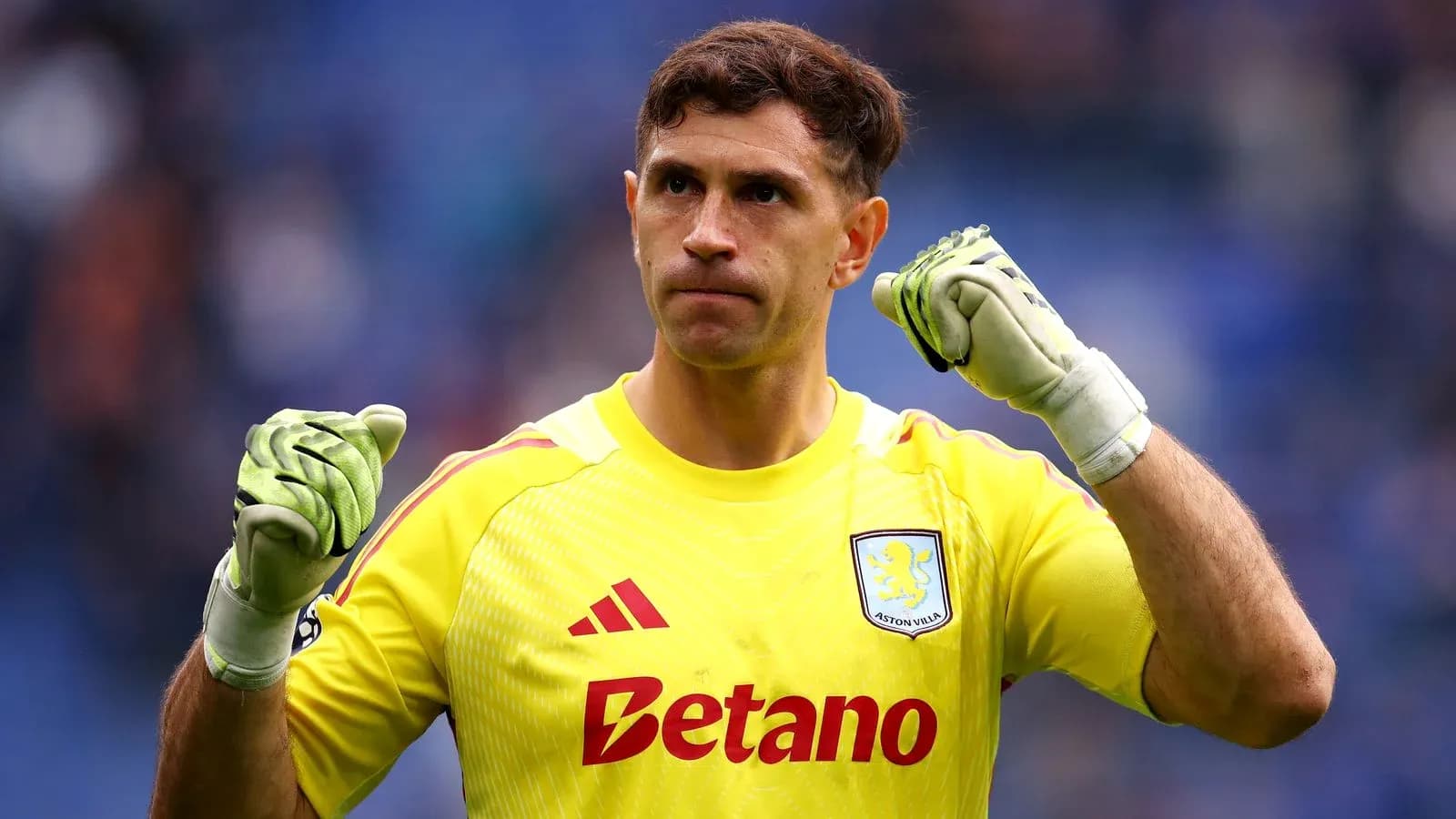 Goalkeeper celebrating in yellow kit with gloves Goalkeeper celebrating in yellow kit with gloves