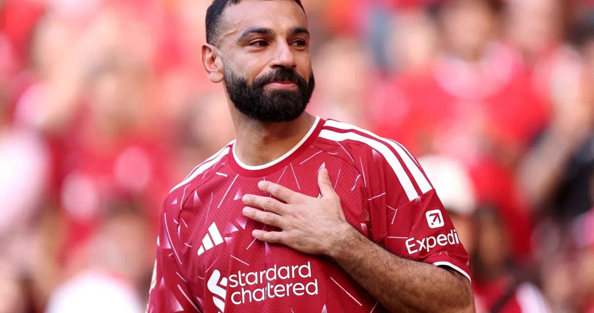 Player wearing red jersey gestures to crowd Player wearing red jersey gestures to crowd